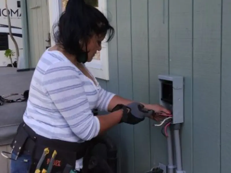 Licensed electrician wiring an exterior subpanel in St. Francis
