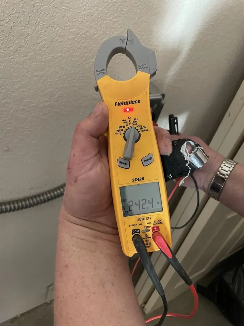 Voltage testing with clamp meter during Recessed Lighting Installation in St. Francis